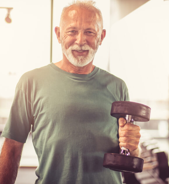 Older man lifting a weight.